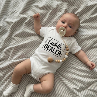 AMA™ "Cuddle Dealer" – Funny Baby Bodysuit